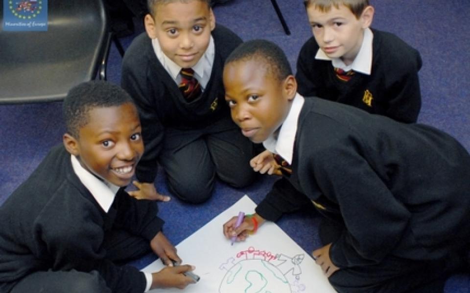 four boys making a piece of art